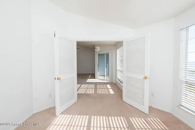 a kitchen with stainless steel appliances granite countertop a refrigerator a sink and white cabinets