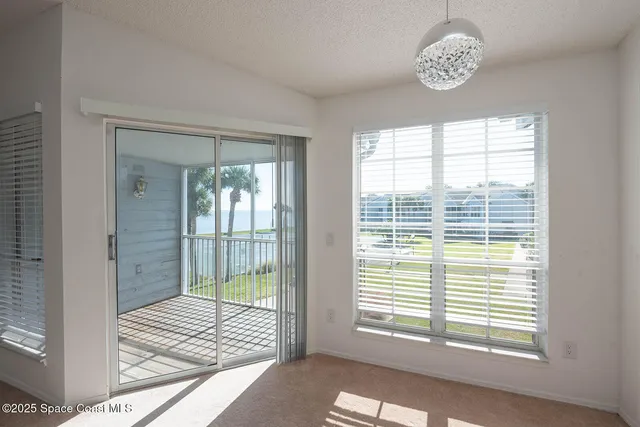a kitchen with granite countertop a sink and white cabinets