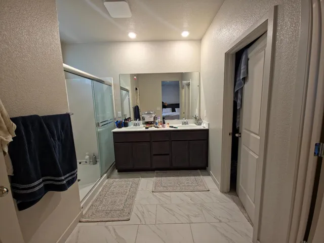 a room with a refrigerator and a mirror