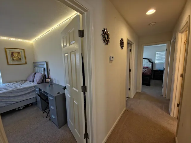 a view of a hallway with workspace and a bathroom