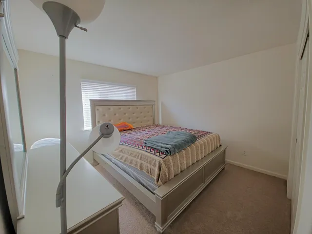 a bedroom with a bed and a mirror