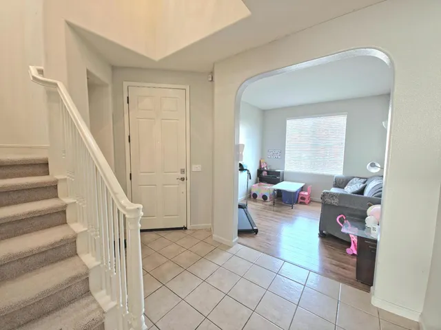 a living room with furniture and stairs