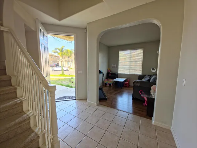 a view of a livingroom and a livingroom with furniture and an entryway