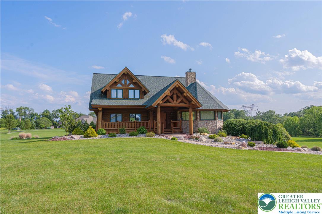 a front view of a house with a garden and trees