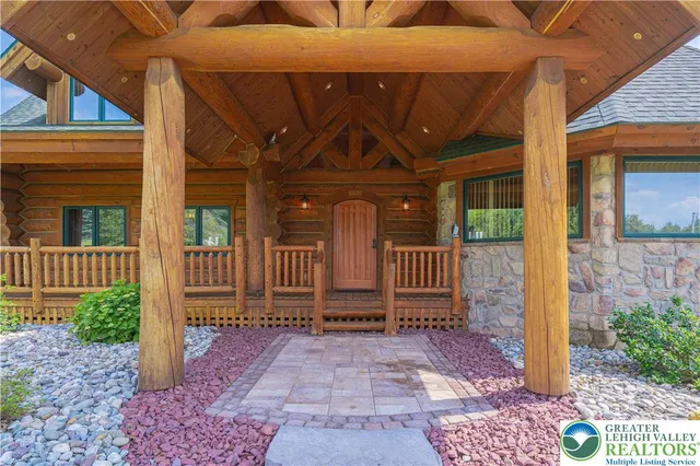 a living room with furniture a rug and a large window