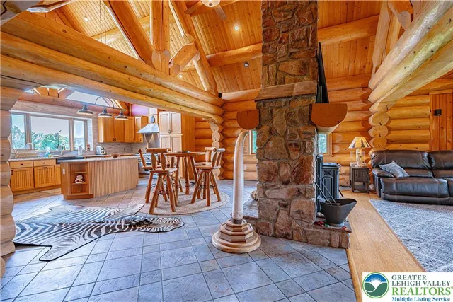 a kitchen with stainless steel appliances granite countertop a refrigerator a sink a stove and a refrigerator