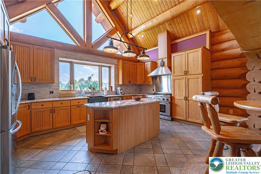 379 Meyer Road Nazareth, PA 18064 - Photo 31 of 78 a kitchen with stainless steel appliances granite countertop a stove a sink and a microwave