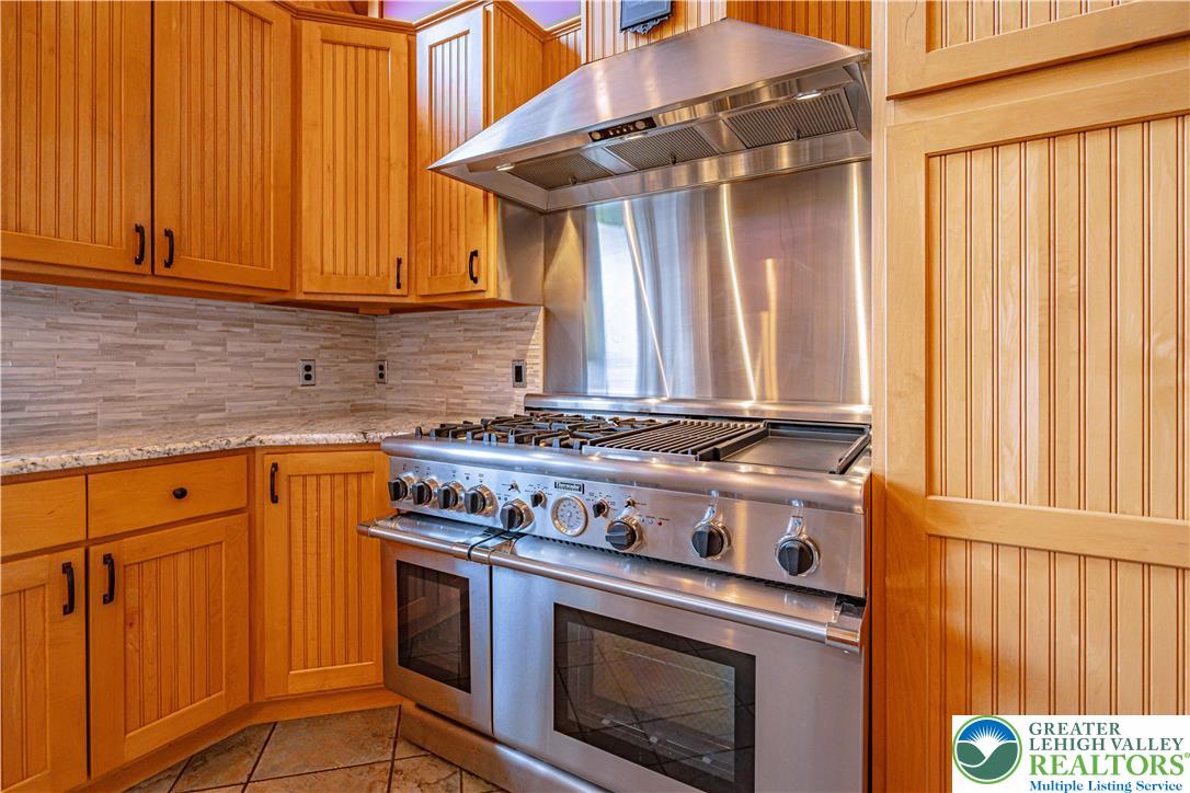 379 Meyer Road Nazareth, PA 18064 - Photo 39 of 78 a kitchen with stainless steel appliances granite countertop a stove and a microwave
