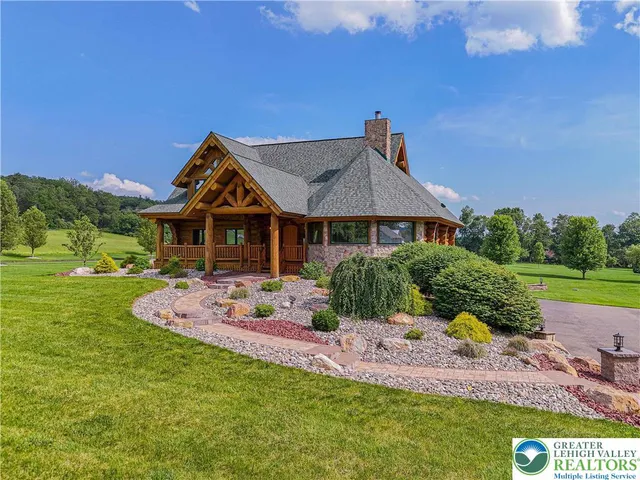 a view of a house with a big yard and garden