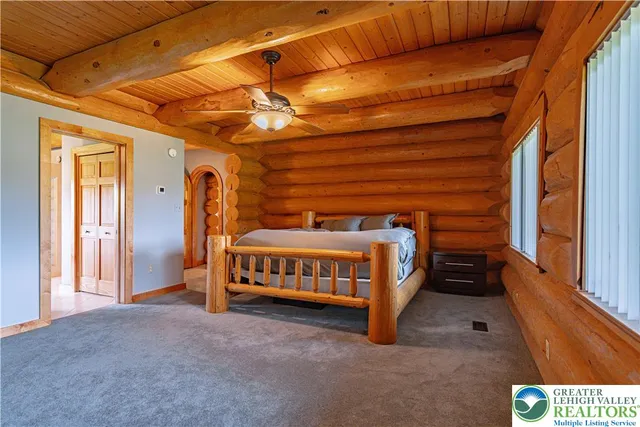 a view of a room with a large window and wooden floor