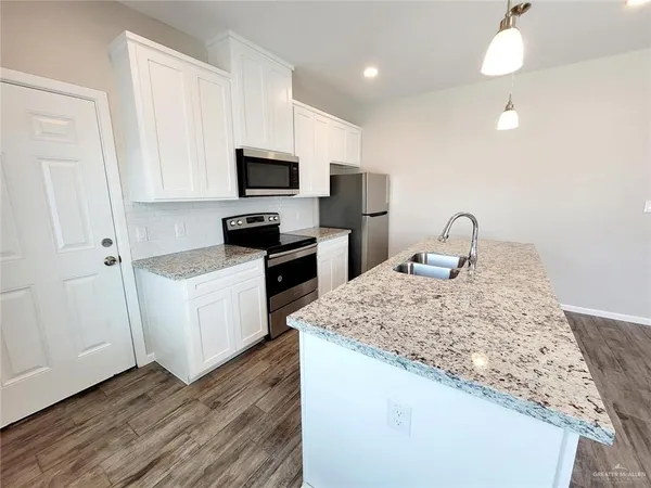 a view of a kitchen with a sink and a window