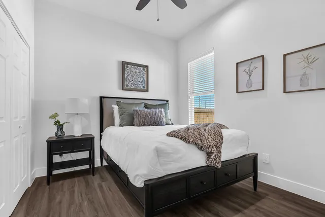 a bedroom with a bed and a chandelier