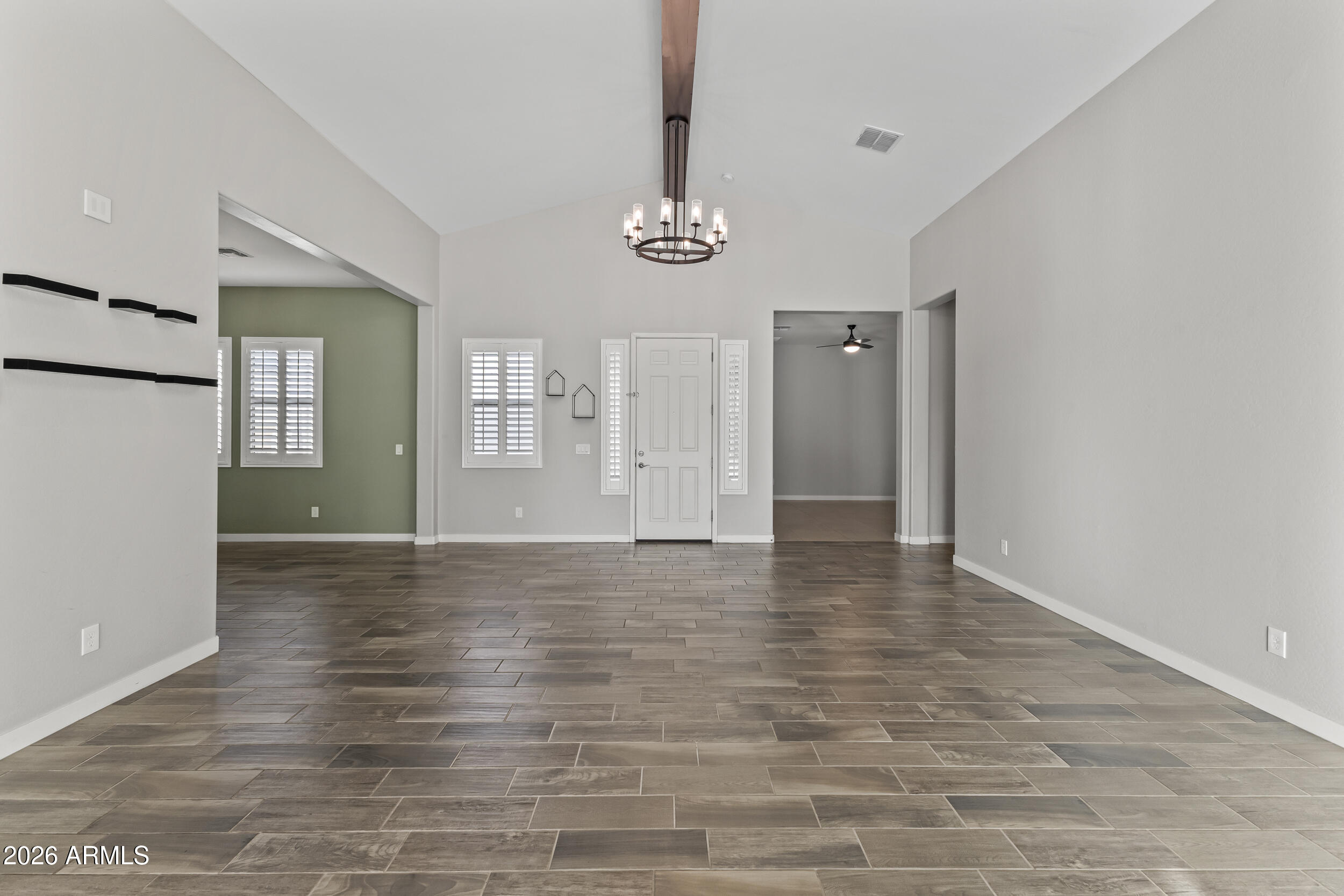 5255 North Ginning Road Litchfield Park, AZ 85340 - Photo 12 of 60 a view of an empty room with window and wooden floor