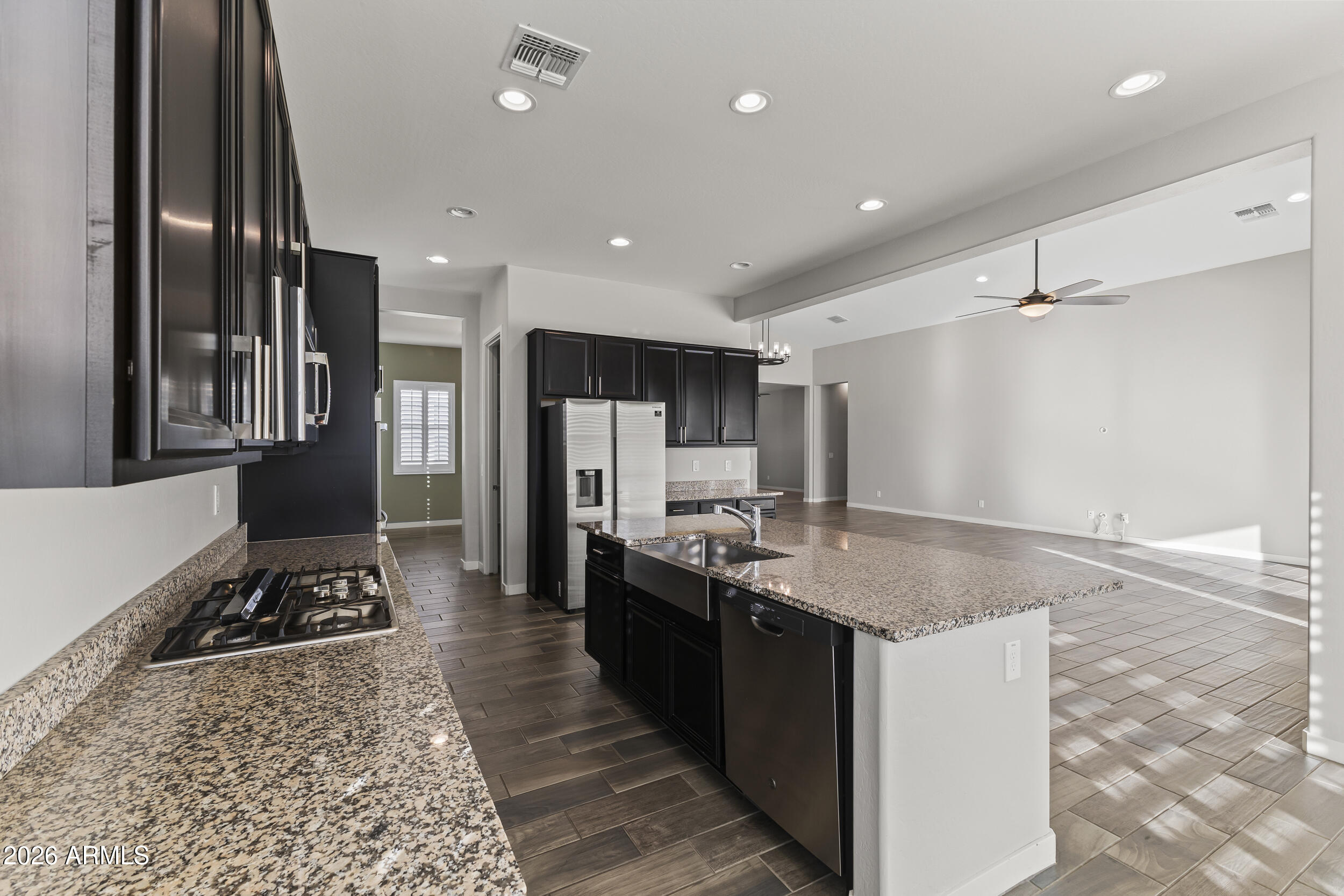 5255 North Ginning Road Litchfield Park, AZ 85340 - Photo 20 of 60 a kitchen with stainless steel appliances granite countertop a sink stove and refrigerator