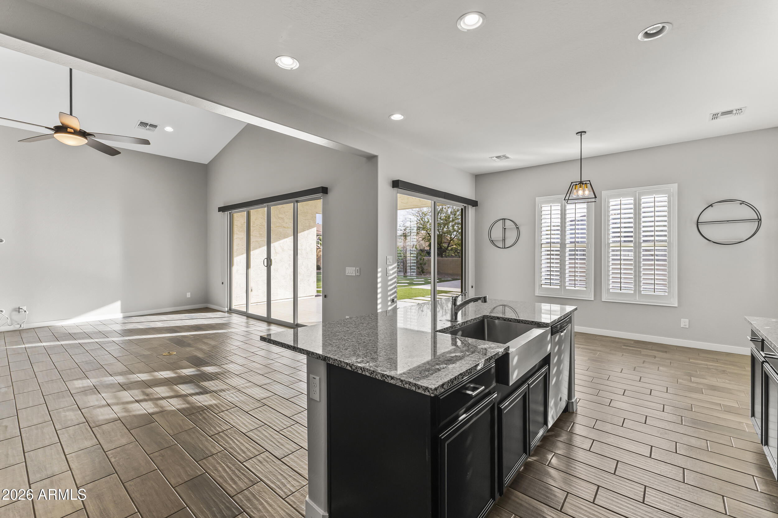 5255 North Ginning Road Litchfield Park, AZ 85340 - Photo 22 of 60 a kitchen with granite countertop a sink and a stove