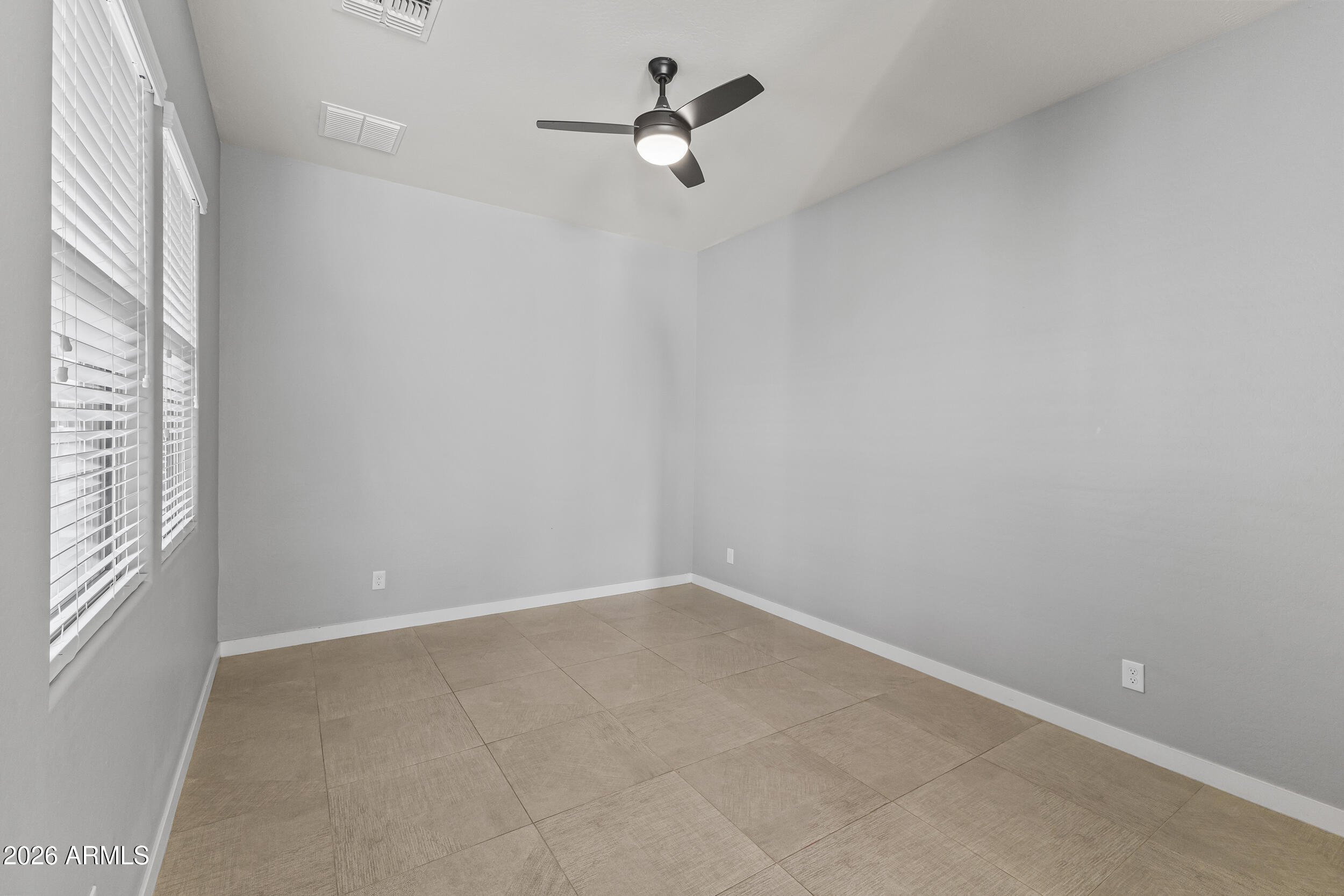 5255 North Ginning Road Litchfield Park, AZ 85340 - Photo 27 of 60 wooden floor in an empty room with a window