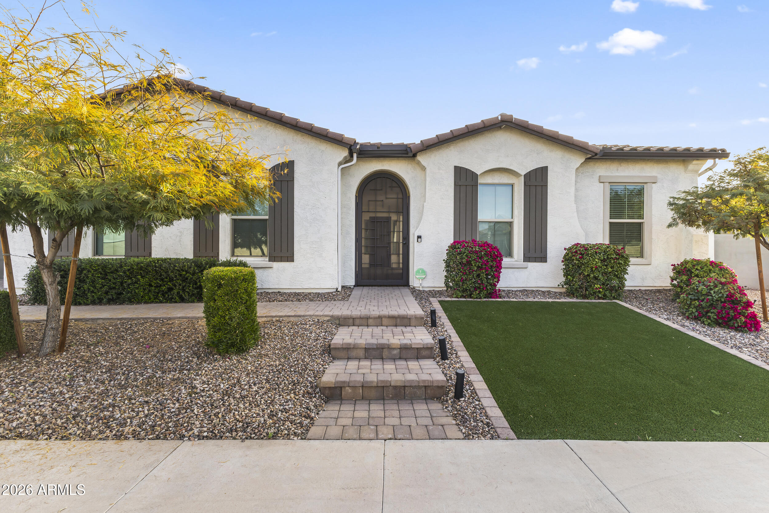 5255 North Ginning Road Litchfield Park, AZ 85340 - Photo 2 of 60 a front view of a house with garden