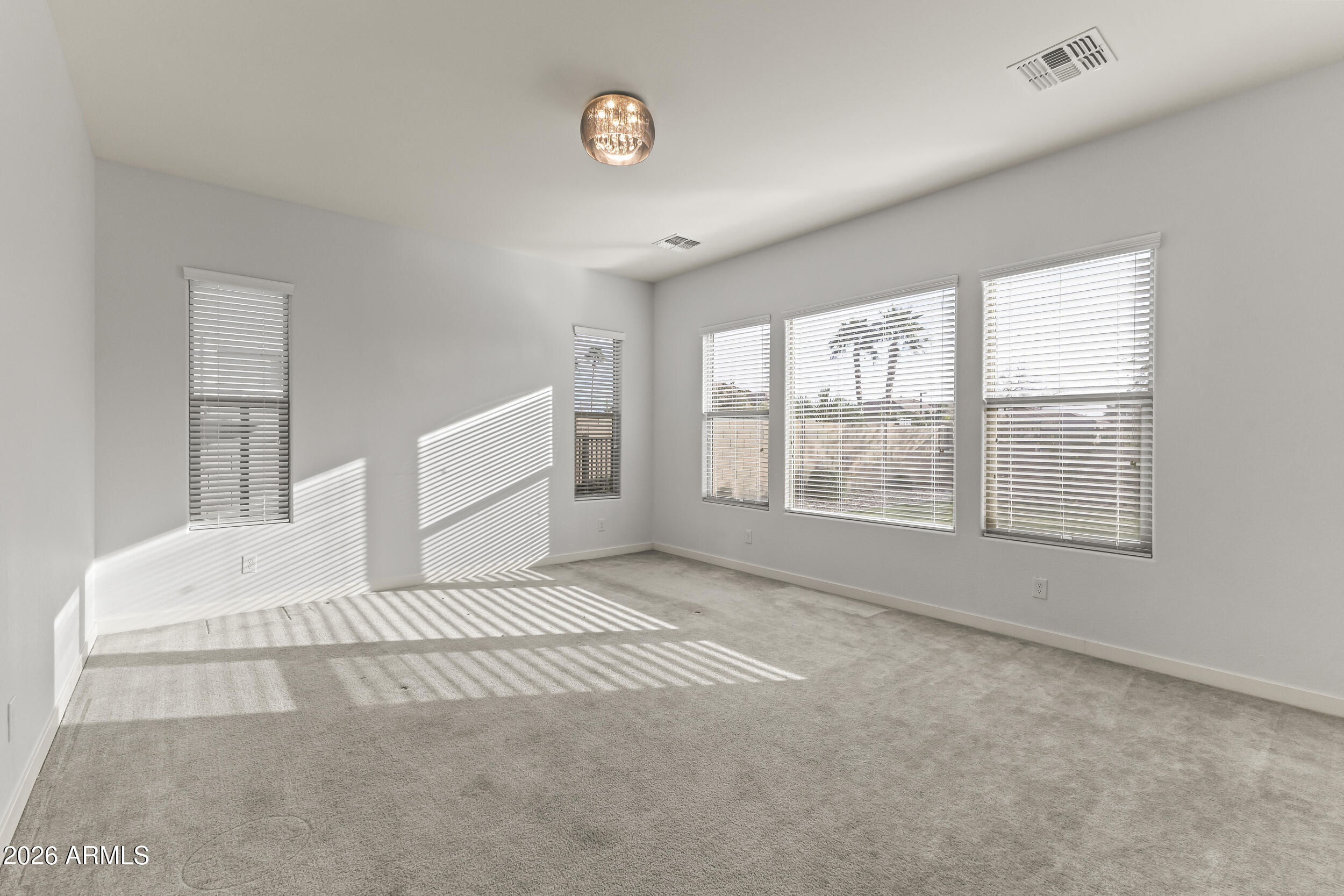 5255 North Ginning Road Litchfield Park, AZ 85340 - Photo 36 of 60 a spacious bedroom with a large bed and a window