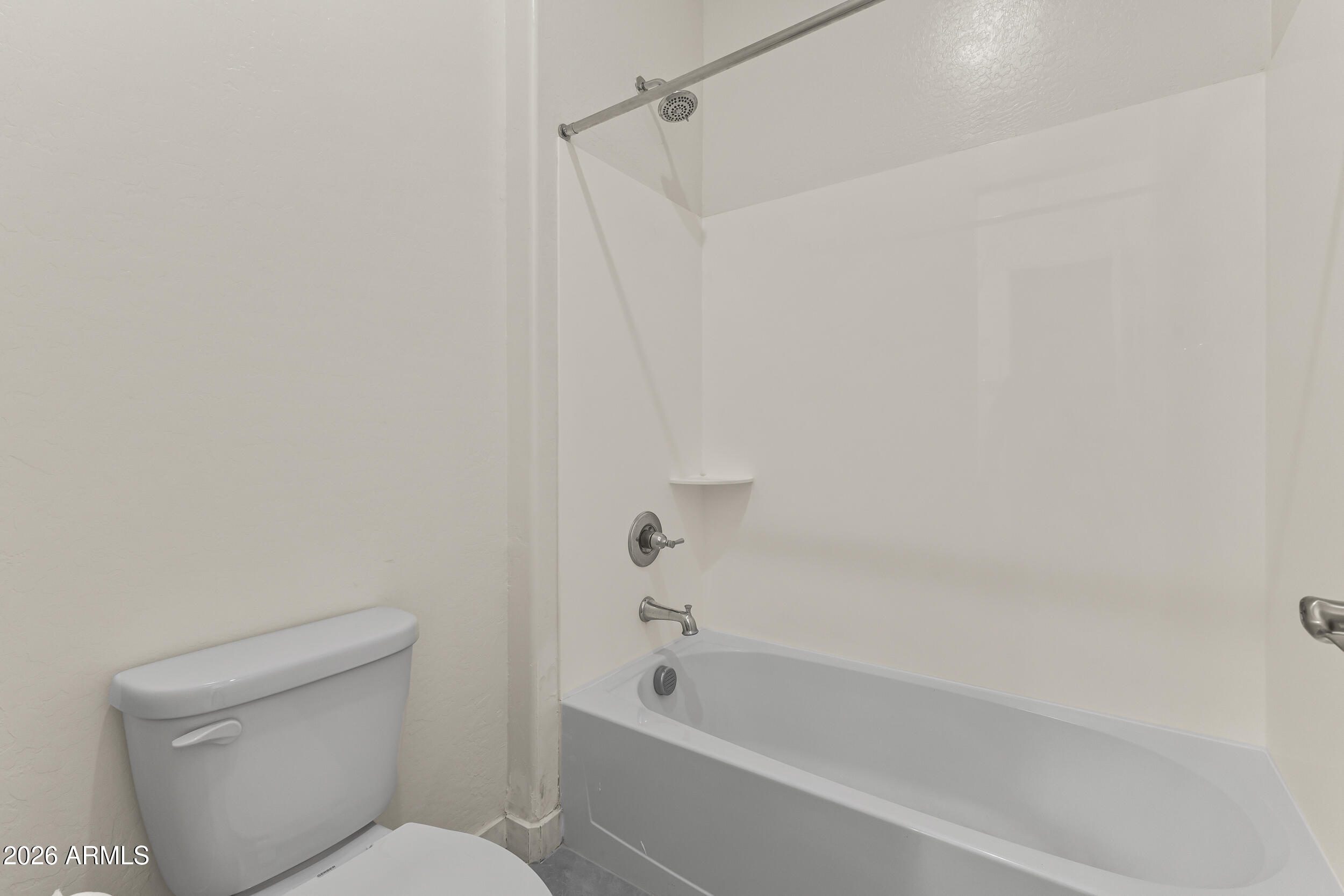 5255 North Ginning Road Litchfield Park, AZ 85340 - Photo 39 of 60 a bathroom with a toilet and a bathtub