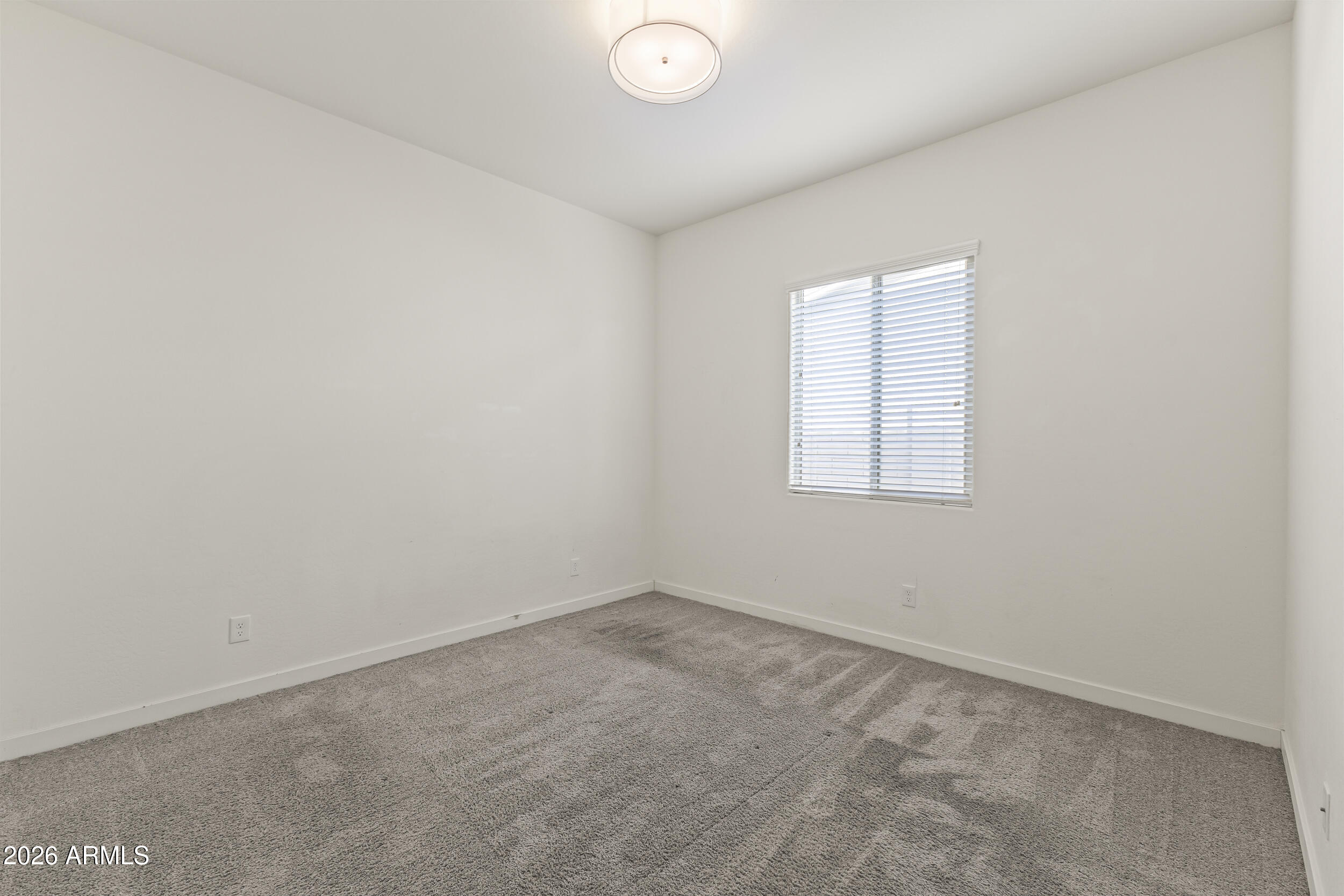 5255 North Ginning Road Litchfield Park, AZ 85340 - Photo 40 of 60 an empty room with a window