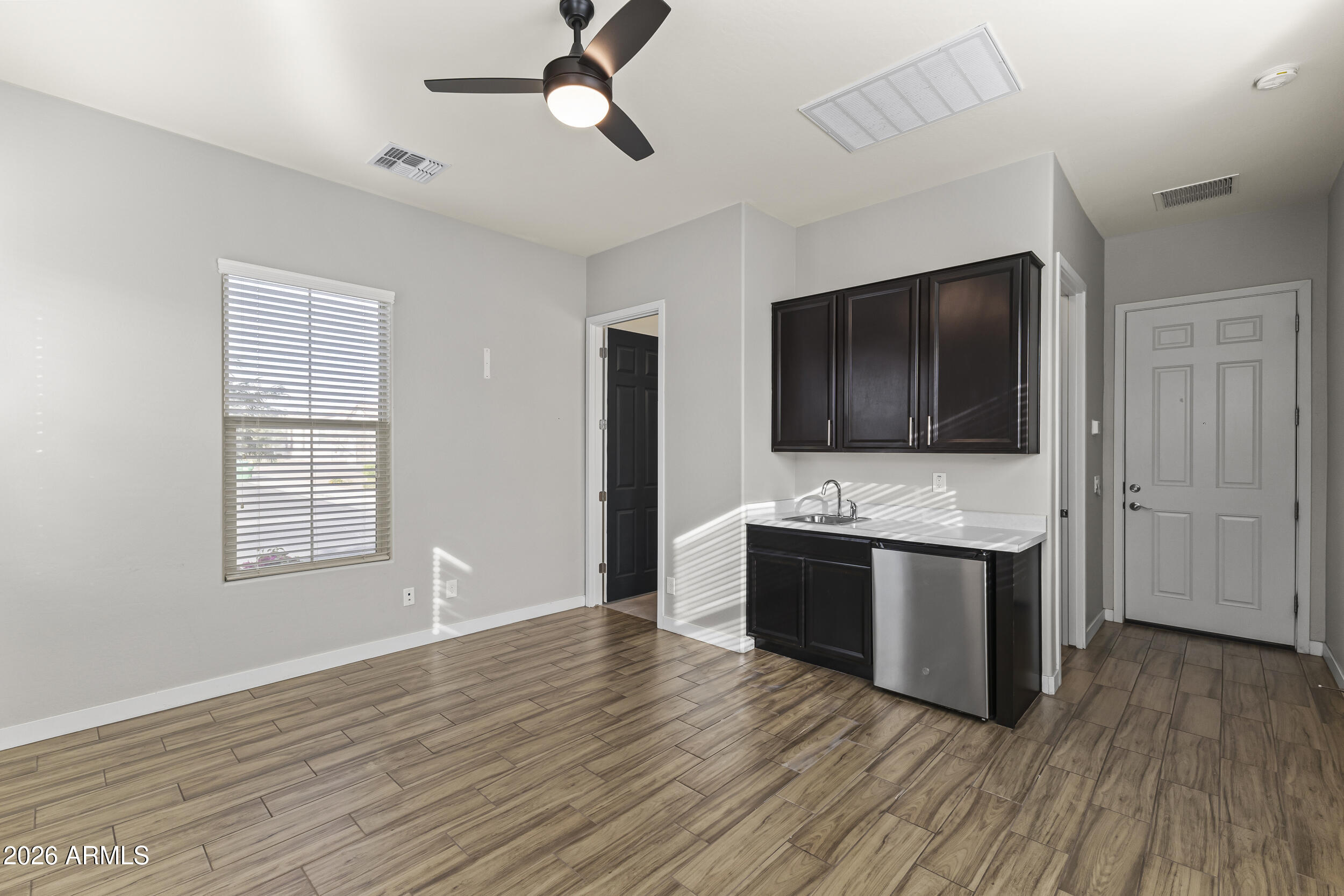 5255 North Ginning Road Litchfield Park, AZ 85340 - Photo 7 of 60 a view living room with stainless steel appliances wooden floor and chandelier