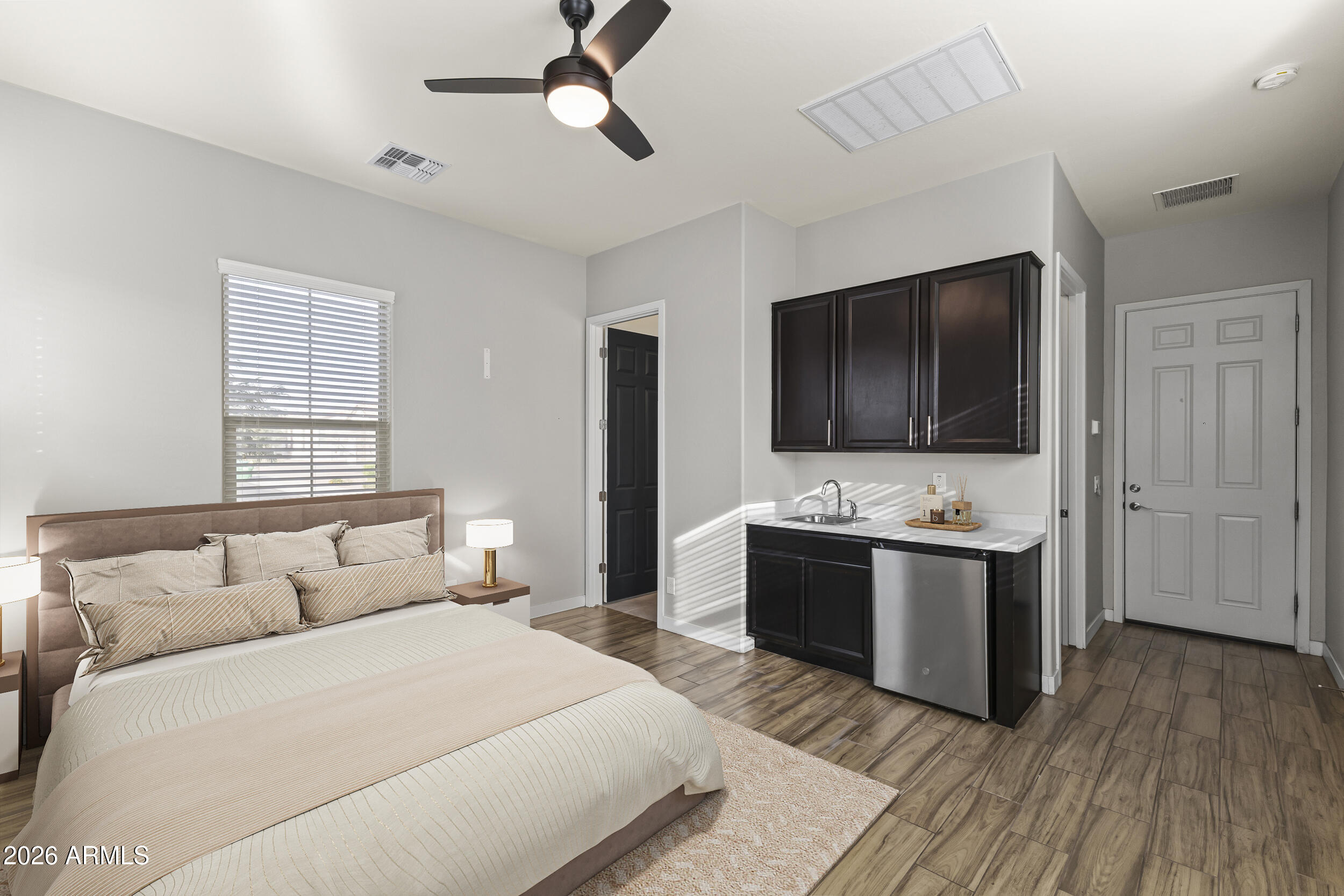 5255 North Ginning Road Litchfield Park, AZ 85340 - Photo 8 of 60 a bedroom with a bed and a flat screen tv