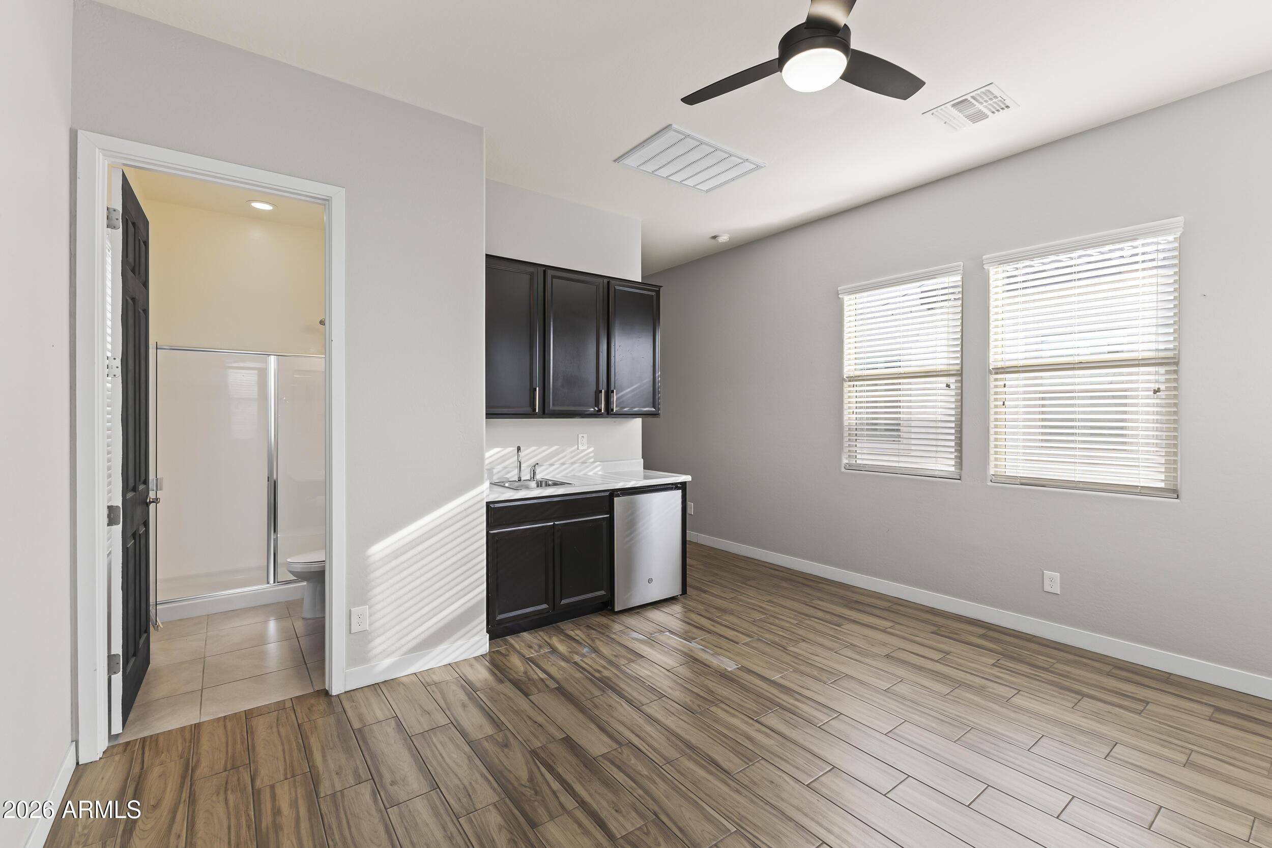 5255 North Ginning Road Litchfield Park, AZ 85340 - Photo 9 of 60 a kitchen with stainless steel appliances kitchen island granite countertop a stove and a refrigerator