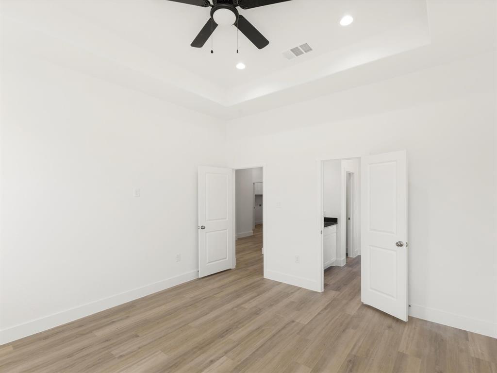 111 West Farmers Road Seagoville, TX 75159 - Photo 12 of 32 a view of a room with wooden floor and white walls