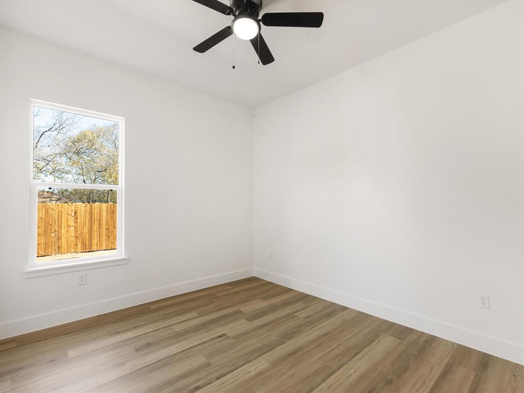 111 West Farmers Road Seagoville, TX 75159 - Photo 17 of 32 wooden floor in an empty room with a window