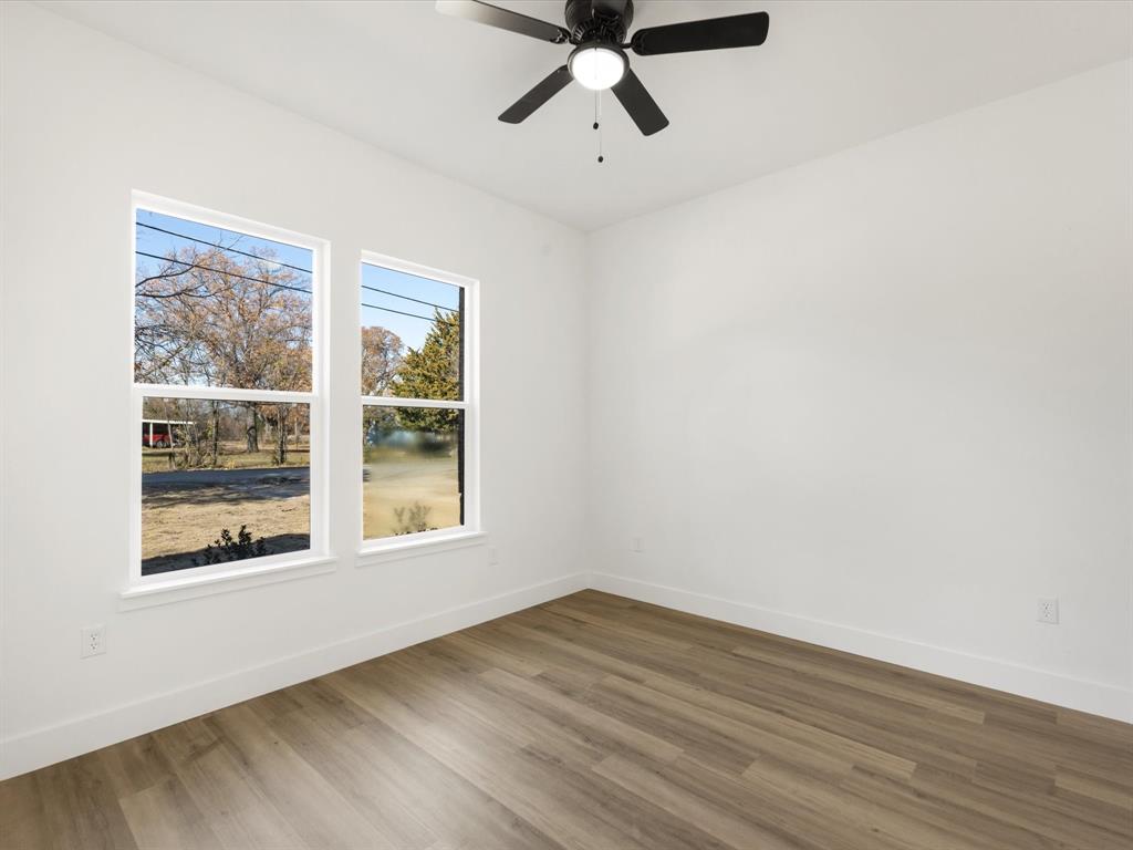 111 West Farmers Road Seagoville, TX 75159 - Photo 18 of 32 a view of empty room with wooden floor and fan