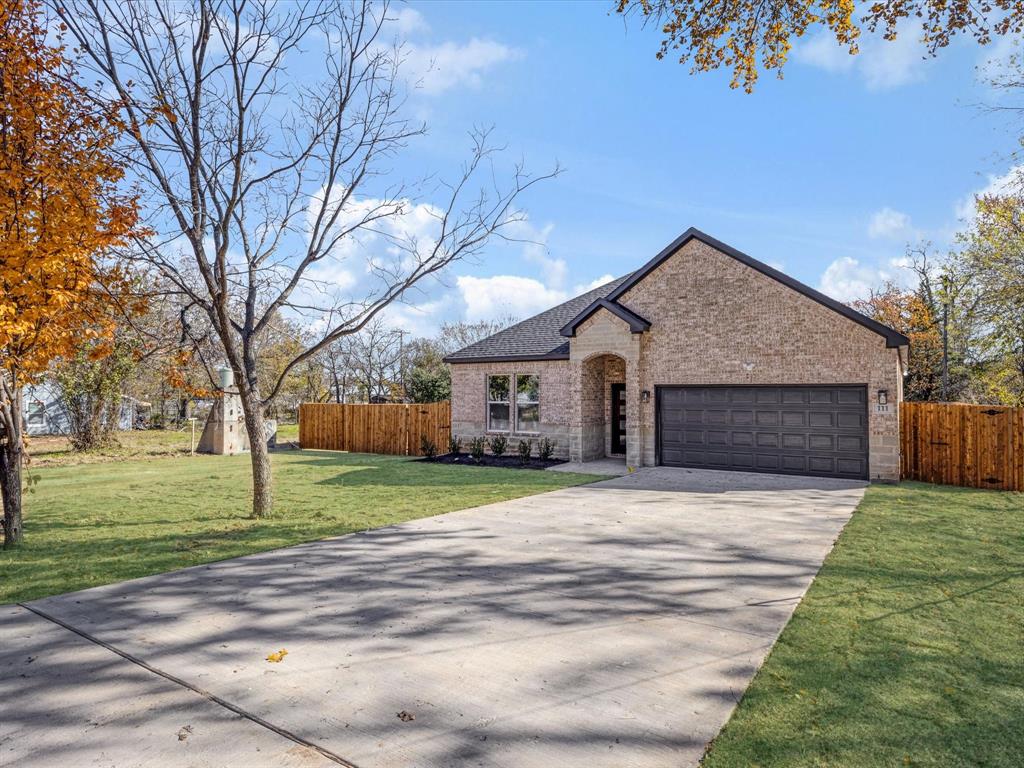 111 West Farmers Road Seagoville, TX 75159 - Photo 4 of 32 a front view of a house with a yard and garage