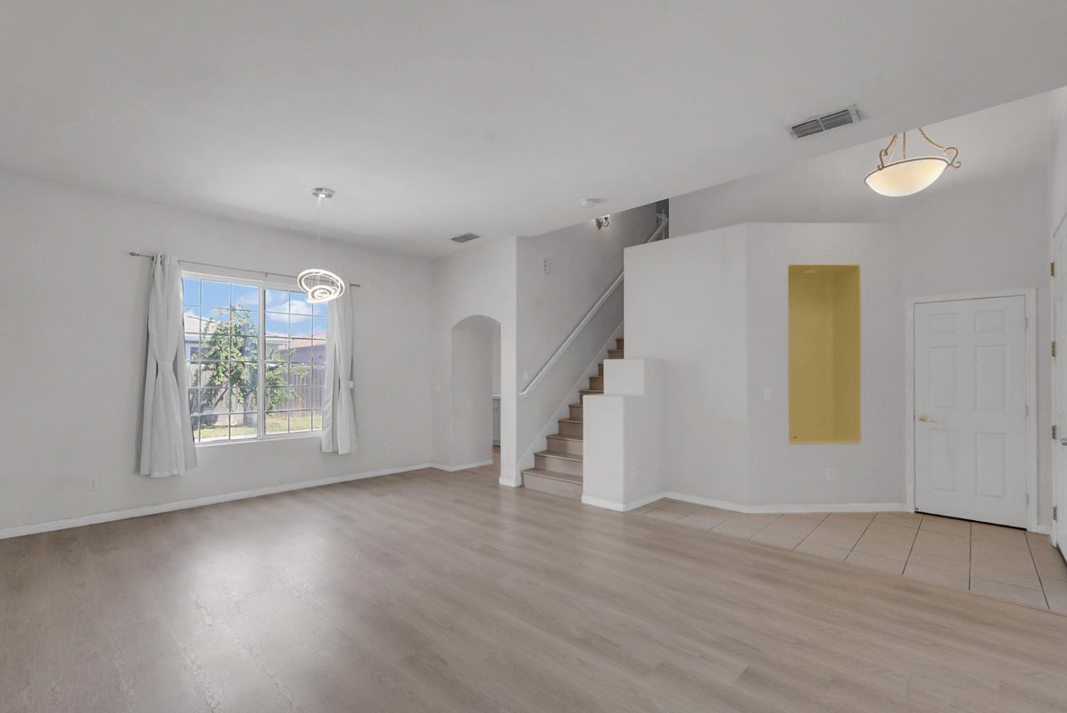 1412 Red Ribbons Lane Manteca, CA 95337 - Photo 5 of 32 an empty room with wooden floor and windows