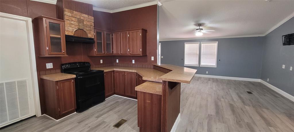 5543 Upper Denton Road Weatherford, TX 76085 - Photo 10 of 23 a kitchen with granite countertop a sink stove and cabinets