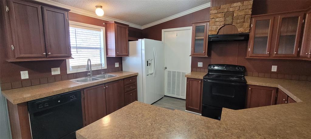 5543 Upper Denton Road Weatherford, TX 76085 - Photo 11 of 23 a kitchen with stainless steel appliances granite countertop a refrigerator and a sink