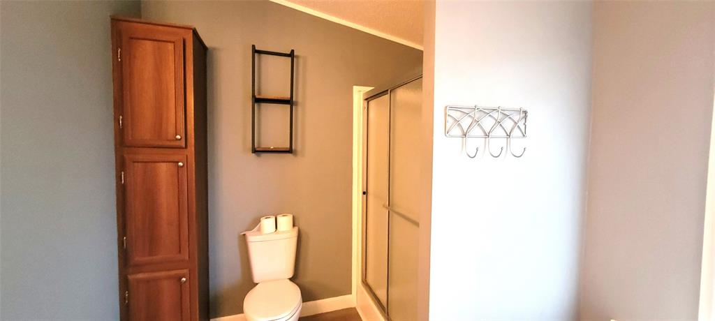 5543 Upper Denton Road Weatherford, TX 76085 - Photo 19 of 23 a bathroom with a toilet shower and mirror