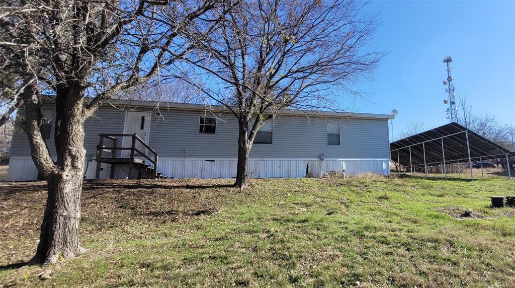 5543 Upper Denton Road Weatherford, TX 76085 - Photo 7 of 23 a house with trees in front of it