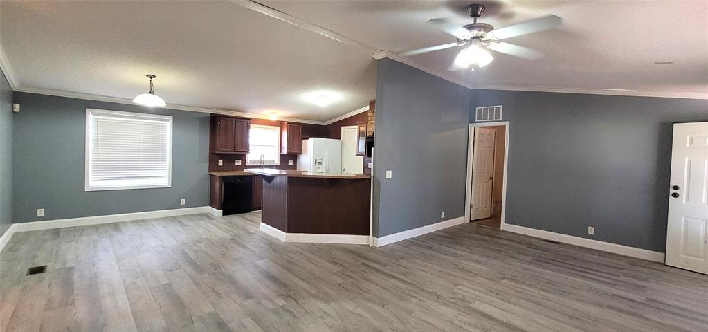 5543 Upper Denton Road Weatherford, TX 76085 - Photo 22 of 23 a view of a kitchen with wooden floor and a kitchen