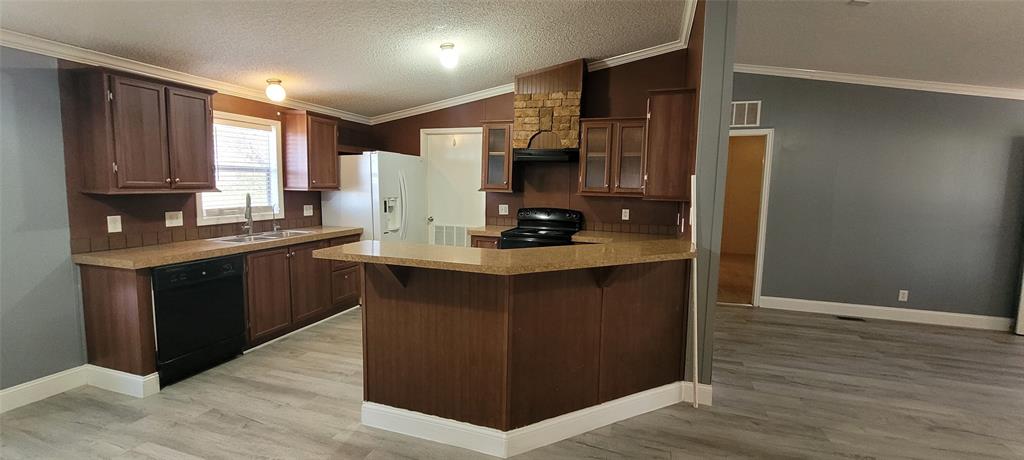 5543 Upper Denton Road Weatherford, TX 76085 - Photo 9 of 23 a kitchen with stainless steel appliances granite countertop a refrigerator and a stove