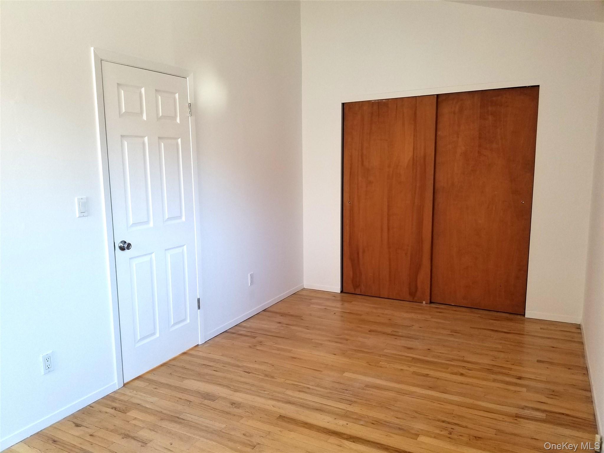 70 Hickory Road, Unit B Port Washington, NY 11050 - Photo 12 of 18 a view of an empty room with wooden floor