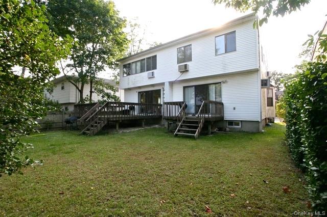 70 Hickory Road, Unit B Port Washington, NY 11050 - Photo 18 of 18 a view of a house with backyard sitting area and garden