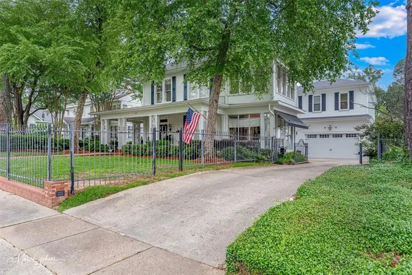 a view of a house next to a yard