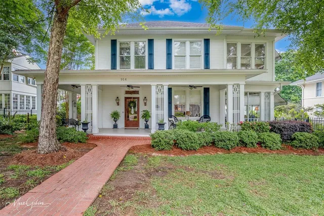 a front view of a house with garden and porch