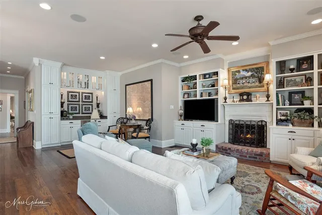 a living room with fireplace furniture and a flat screen tv