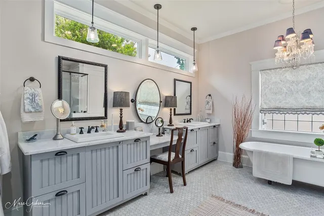 a large white kitchen with a large window