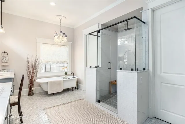 a spacious bedroom with a bed and a chandelier