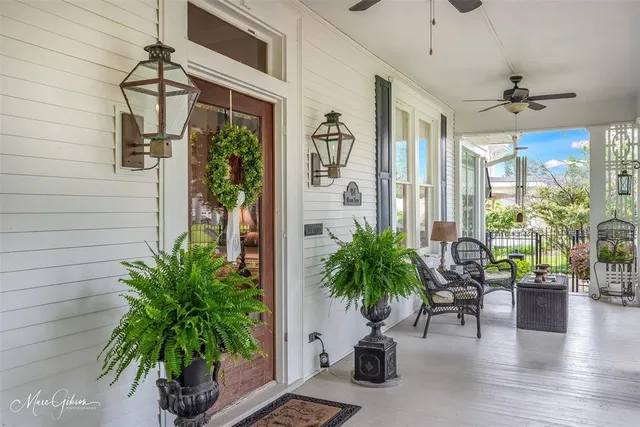 a hallway with potted plants and couches