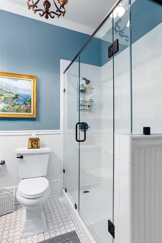a bathroom with a toilet and a shower
