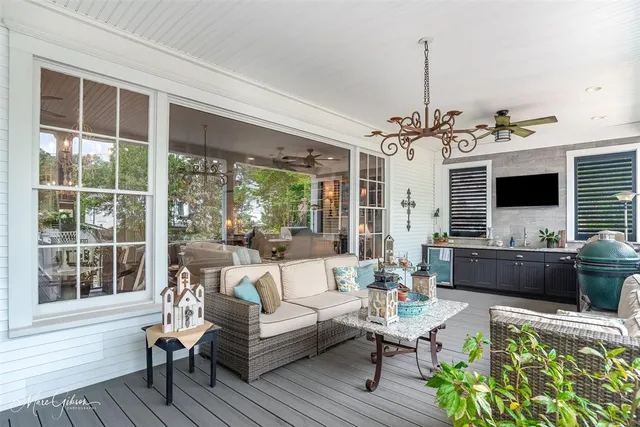 a living room with furniture a flat screen tv and a window