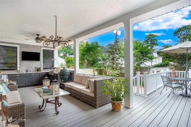 a living room with patio furniture and a wooden floor