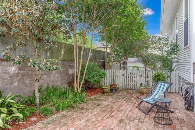 a view of a chair and table in backyard
